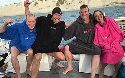 open sea swimmers on boat